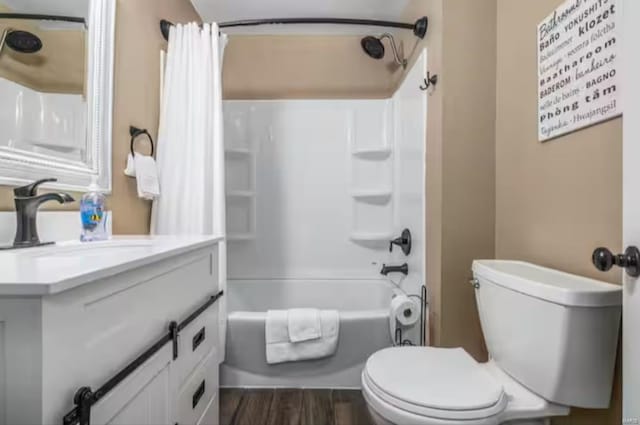 full bathroom with hardwood / wood-style floors, shower / bath combination with curtain, toilet, and vanity