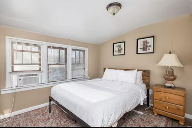 bedroom with cooling unit and vaulted ceiling