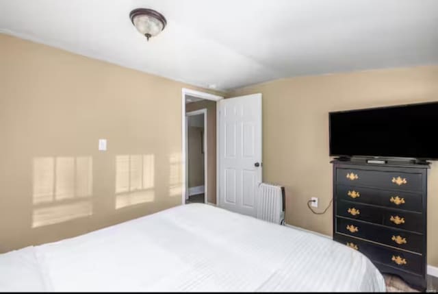 bedroom with radiator heating unit