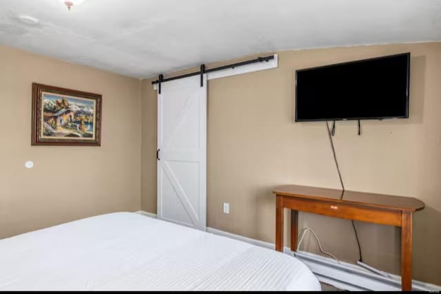 unfurnished bedroom with a barn door