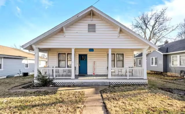 bungalow-style house with central air condition unit and a porch