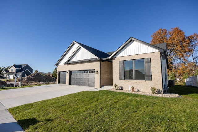 view of front of property featuring a front yard, a garage, and central AC unit