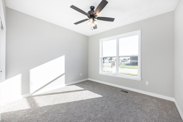 spare room featuring carpet and ceiling fan