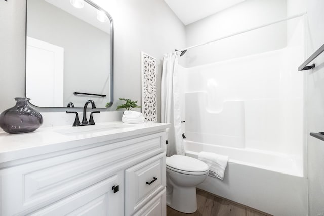 full bathroom featuring hardwood / wood-style floors, shower / bath combo, toilet, and vanity