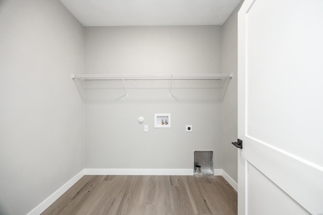 washroom featuring hookup for a washing machine, light hardwood / wood-style floors, hookup for a gas dryer, and electric dryer hookup