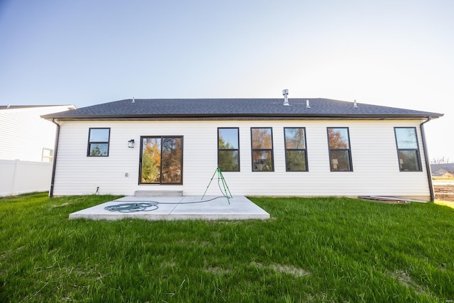 back of house featuring a lawn and a patio area