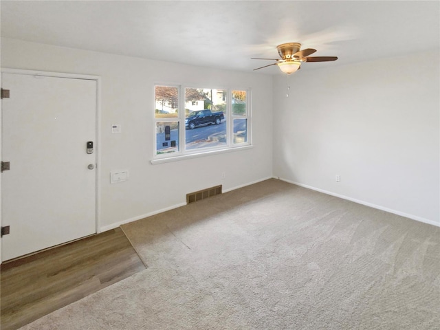 interior space with carpet flooring and ceiling fan