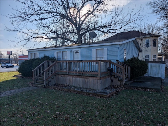 view of front of house with a front lawn and a wooden deck