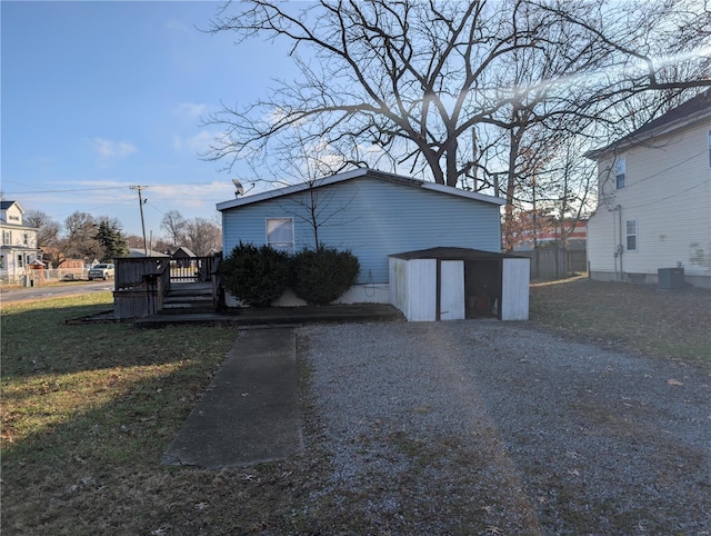 exterior space featuring a lawn and central AC