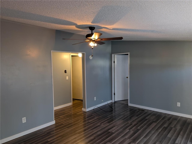 spare room featuring ceiling fan, dark hardwood / wood-style floors, lofted ceiling, and a textured ceiling