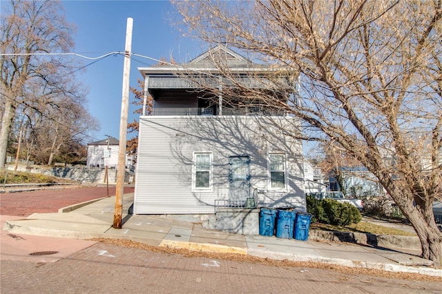 view of side of home featuring a balcony