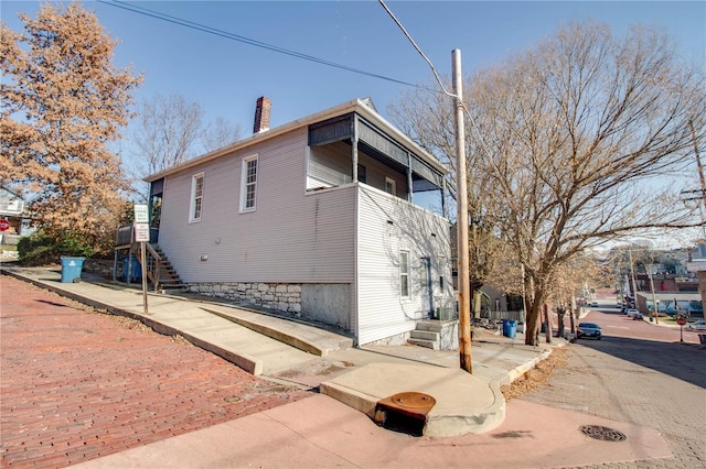 view of property exterior with a chimney