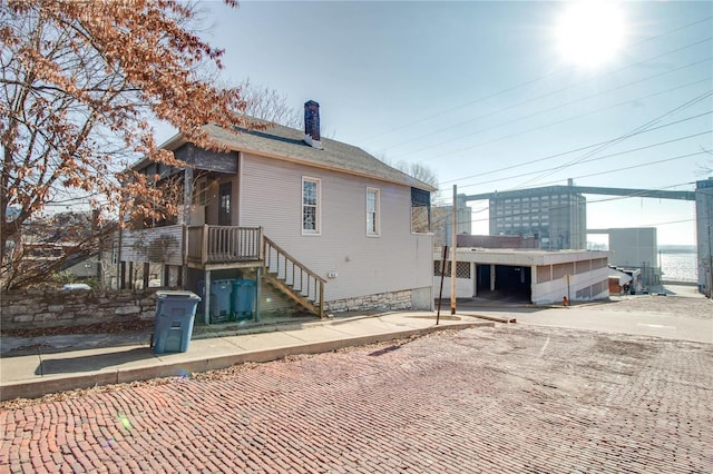 rear view of property with a chimney