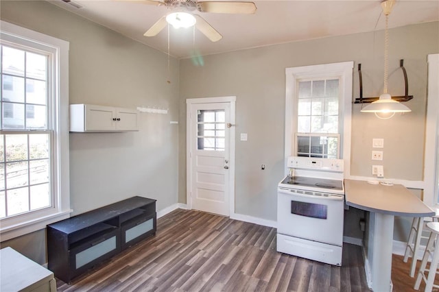 kitchen featuring a breakfast bar area, dark wood-style flooring, light countertops, white cabinetry, and white range with electric cooktop