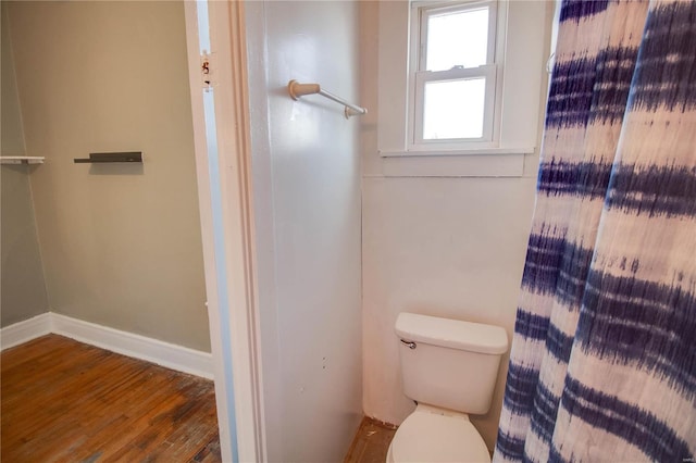 full bathroom with wood finished floors, toilet, and baseboards