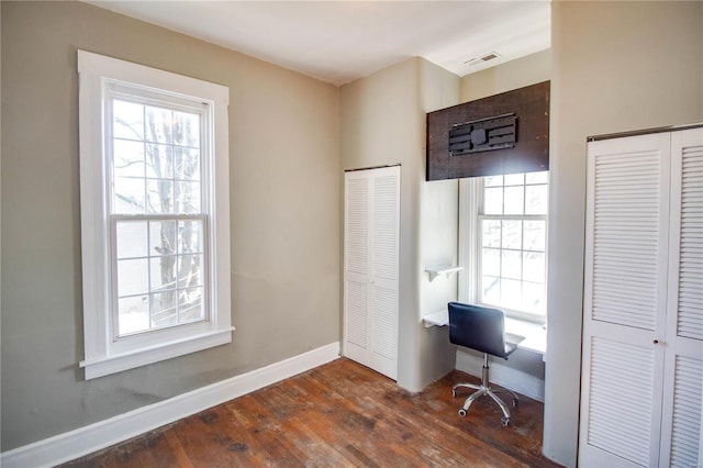 office space featuring dark wood-style floors, visible vents, and baseboards