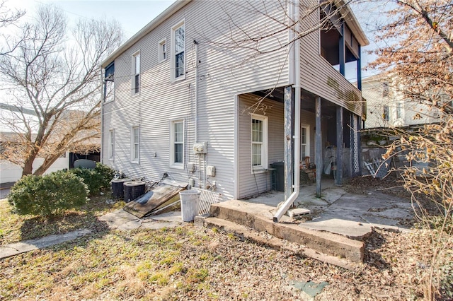 rear view of house with central AC unit