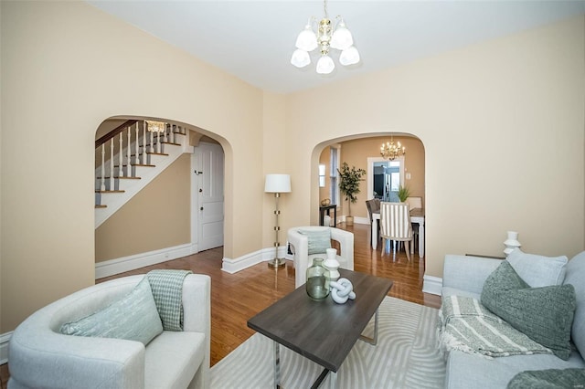 living room with hardwood / wood-style flooring and an inviting chandelier