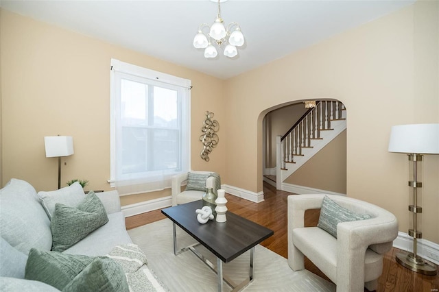 living room featuring light wood-type flooring and a notable chandelier