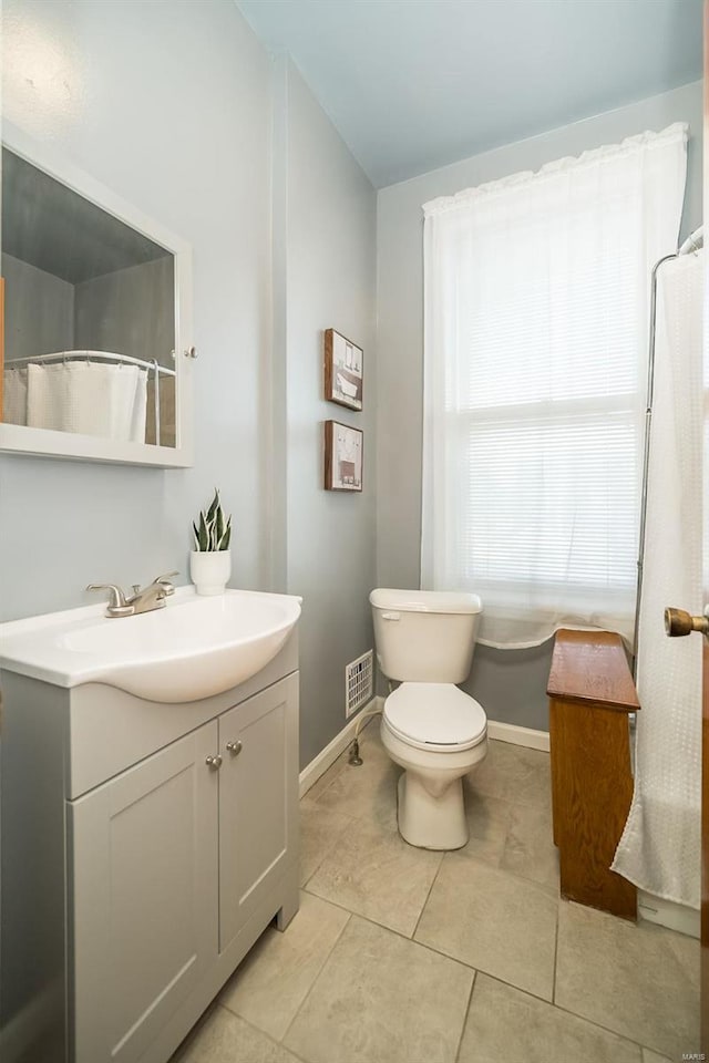 bathroom with tile patterned floors, vanity, and toilet