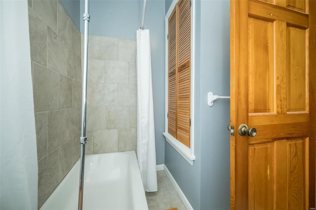 bathroom featuring tile patterned floors and shower / bath combo with shower curtain