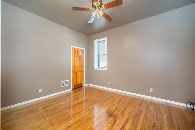 empty room with ceiling fan and light wood-type flooring