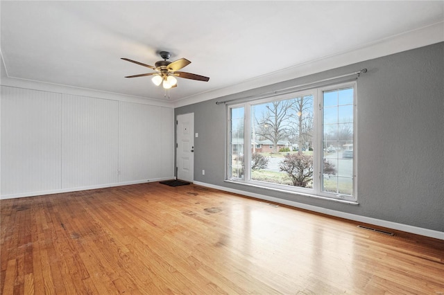 unfurnished room with light hardwood / wood-style flooring, ceiling fan, and crown molding