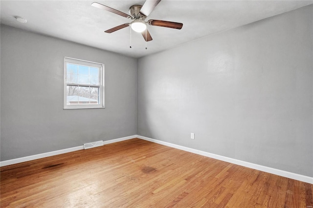 spare room featuring hardwood / wood-style flooring and ceiling fan