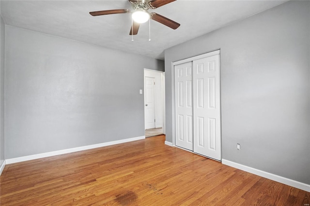 unfurnished bedroom featuring light wood-type flooring, a closet, and ceiling fan