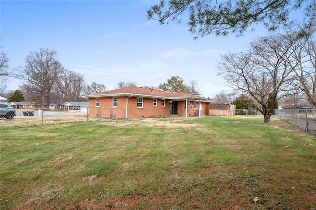 rear view of property featuring a yard