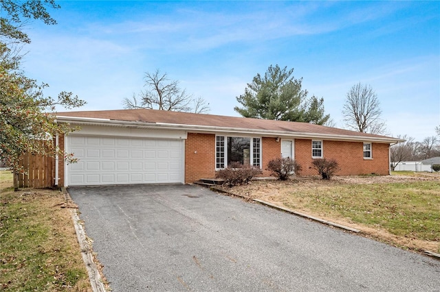 single story home with a front yard and a garage