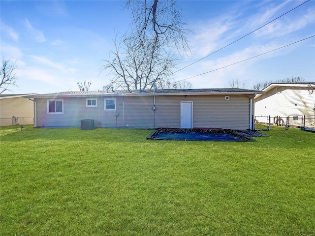 rear view of house with a yard and central air condition unit