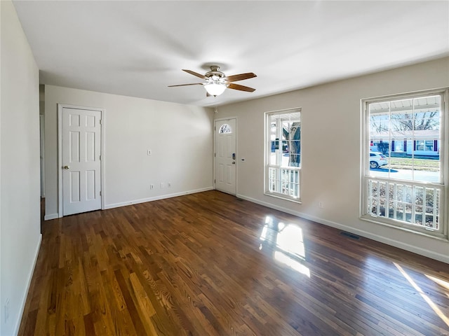 empty room featuring ceiling fan and dark wood-type flooring