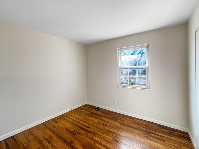 spare room featuring dark wood-type flooring