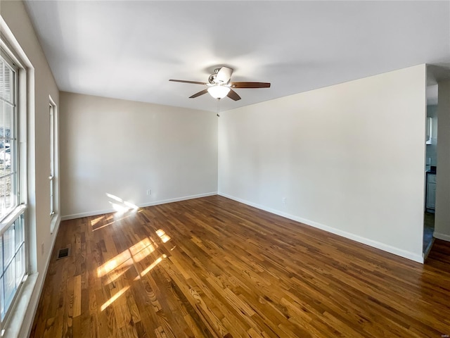 unfurnished room with dark hardwood / wood-style floors and ceiling fan