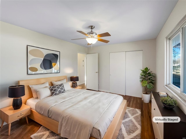 bedroom with a closet, ceiling fan, and dark wood-type flooring