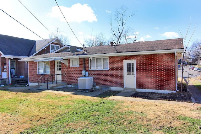 back of property featuring a yard and cooling unit