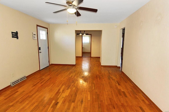 spare room featuring hardwood / wood-style flooring and ceiling fan