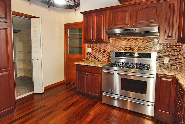 kitchen with decorative backsplash, stainless steel range with gas cooktop, dark hardwood / wood-style flooring, and light stone counters