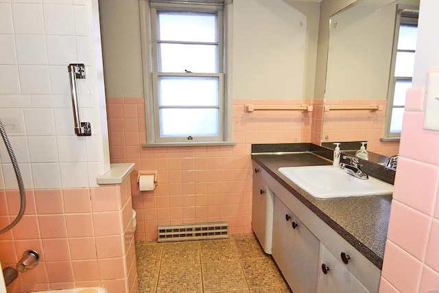 bathroom with vanity and tile walls