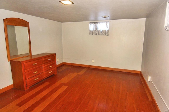 spare room with dark hardwood / wood-style flooring