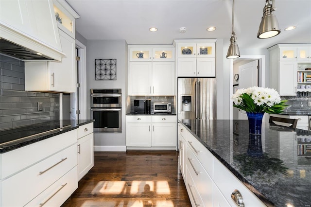 kitchen featuring premium range hood, pendant lighting, white cabinetry, dark hardwood / wood-style flooring, and stainless steel appliances