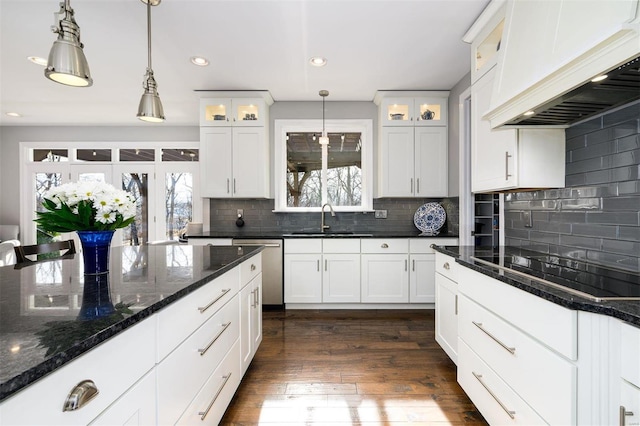 kitchen with custom exhaust hood, hanging light fixtures, black electric stovetop, and white cabinets