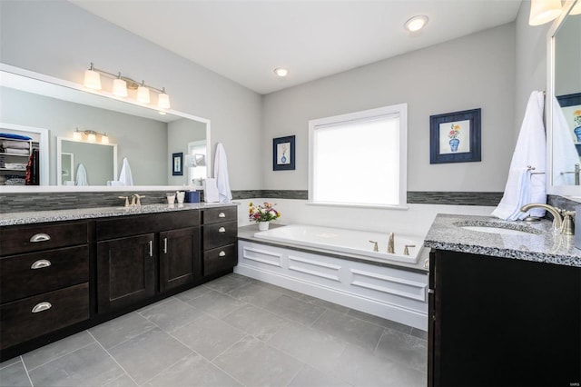 bathroom with vanity and a washtub