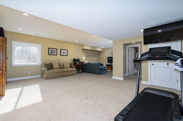 workout room featuring light carpet