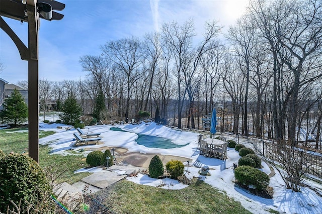 snow covered pool with a patio