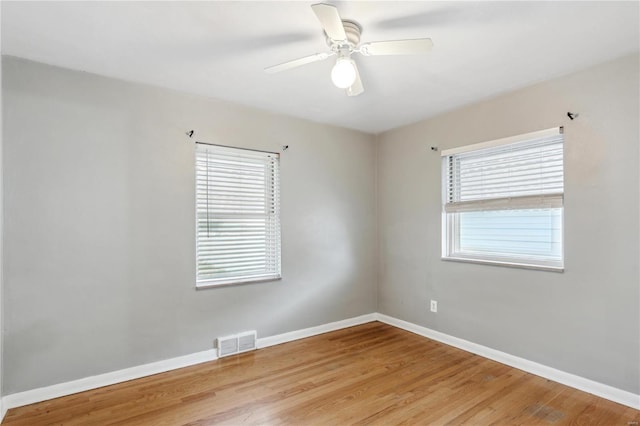 unfurnished room featuring light hardwood / wood-style floors, ceiling fan, and a healthy amount of sunlight