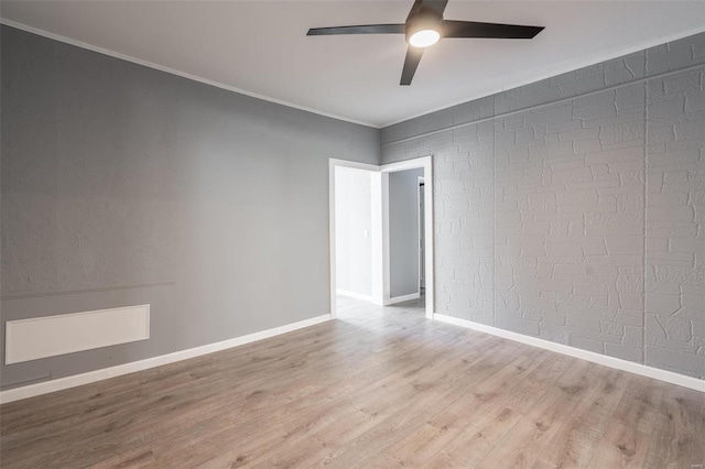 unfurnished room with ceiling fan, light hardwood / wood-style flooring, and crown molding