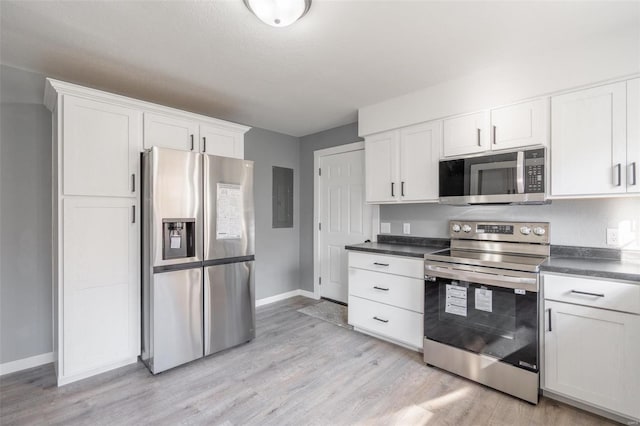 kitchen featuring light wood-type flooring, white cabinetry, and stainless steel appliances