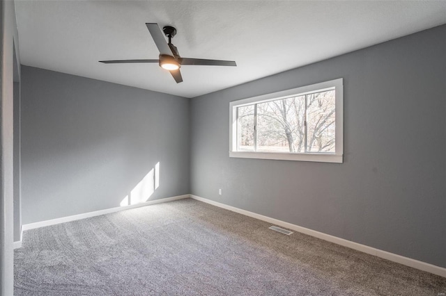 carpeted empty room featuring ceiling fan